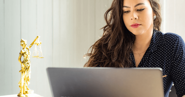 woman looking at her laptop looking for Hiring a Qualified Attorney